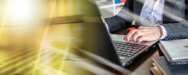 Businesswoman typing on a laptop; multiple exposure