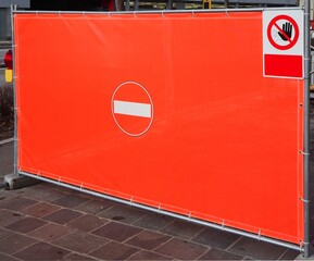Red plastic tarpaulin with painted a  no entry sign in the center, used to temporarily prohibit...