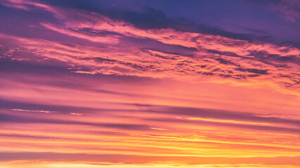 Naklejka na ściany i meble Summer sunset. Evening sky with orange clouds. 