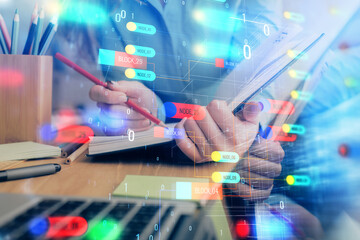 Double exposure of writing hand on background with data technology hologram. Big data concept.
