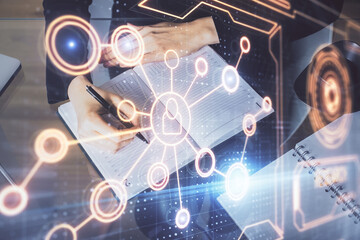 Social network theme hologram over hands taking notes background. Concept of global international people connect. Double exposure