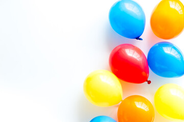 Party concept with colorful balloons on white background top view copy space