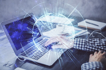 Multi exposure of businessman working on laptop on background. International business hologram in front. Concept of success.