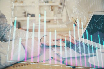 Multi exposure of stock market chart with man working on computer on background. Concept of financial analysis.