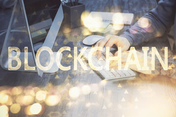Blockchain theme hud with businessman working on computer on background. Concept of crypto chain....