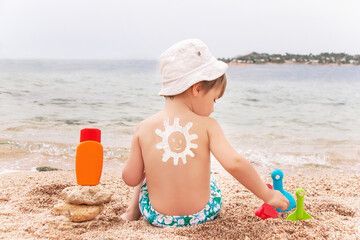 The sun drawing sunscreen on baby (boy)  back.