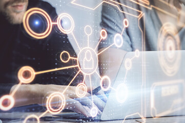 Media network theme hologram with man working on computer on background. Concept of internet...