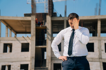 man covered his face with his hand in his palm, surprised apartment specialist