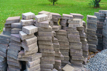 A pile of gray paving tiles on the meadow