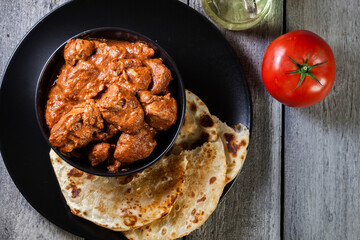 Chicken tikka masala served with bread naan