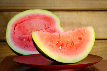 Watermelon on wooden plate over grunge background