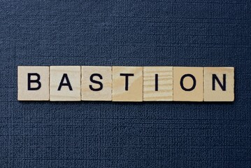  text on word bastion from gray wooden letters on a black background