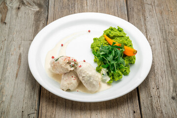 Chicken roll and vegetables on a table. Selective focus.