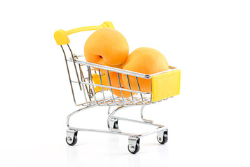 shopping cart full of ripe apricots isolated