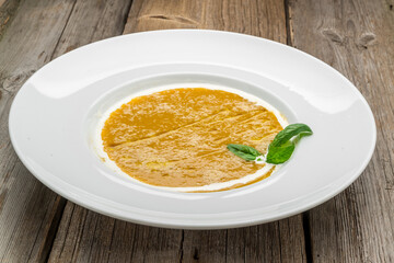 Curried carrot soup with cream and fresh herbs