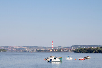 Fototapeta na wymiar Zemun Quay (Zemunski Kej) in Belgrade, Serbia, on the Danube river, seen in summer. Boats can be seen in front, and Belgrade center in background