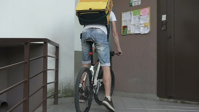 Courier delivery of food by bicycle during an outbreak of the virus. Coronavirus, COVID-19, safe delivery.