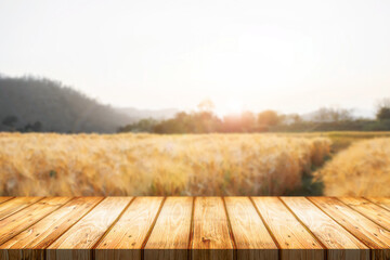 Empty wooden desk space and blurry background of farm for product display montage.