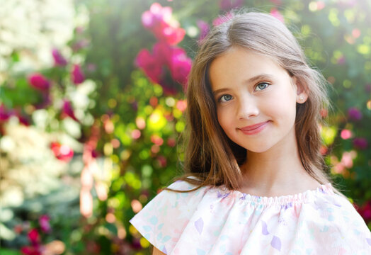 Portrait of adorable smiling little girl child in summer day