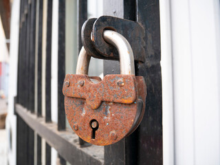 Rusty padlock on the door.