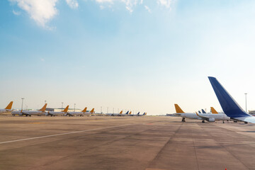 Wings and tails of Comercial airplanes parking at the airport and preparing for flight. Transportation concept. - obrazy, fototapety, plakaty