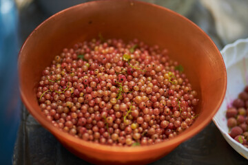 Close-up of white currants in an orange bowl. White creek. Crust close-up. Berries