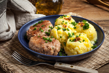 Meatballs served with boiled potatoes.