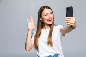 Happy young woman blogger influencer holding modern smart phone wave hand hello. Smiling vlogger...