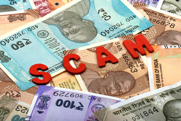 cam and money concept,Scam red alphabets on money background,Indian Currency, Rupee, Indian Rupee,Indian Money, Business, finance, investment, saving and corruption concept

