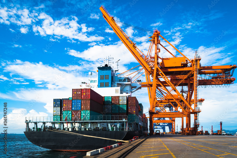 Fototapete huge panamax size container vessel discharging and loading container cargo at port terminal. quay cr