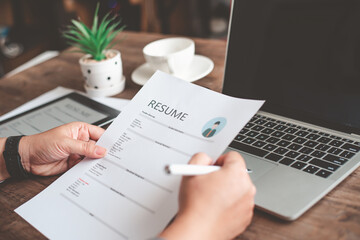 People are reviewing job applications before filling out their resume on the job application form...
