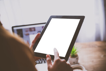 Woman holding blank screen mock up tablet and finger touching