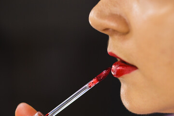Perfect female lips and brush tint for lips lipstick closeup.
