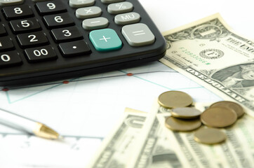  in the frame is a calculator and dollars lying on the graph. bookkeeping