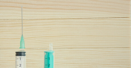  syringes on a wooden background. flu injection. disease injection