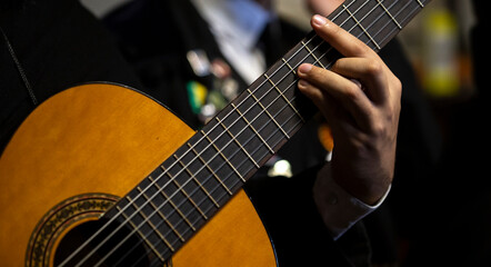 Fototapeta na wymiar Details from a Portuguese guitar musician of an Academic Tuna, Braga, Minho, Portugal.