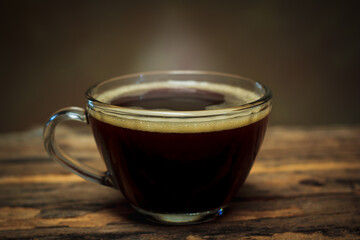A black coffee cup on a wooden table