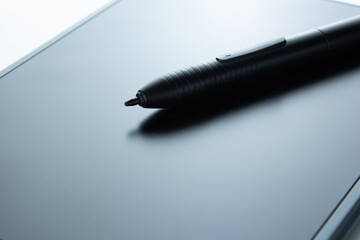 Digital pen lies on graphics tablet, digital drawing