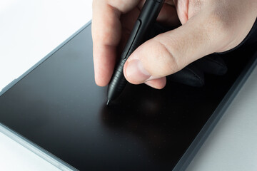 Man draws on a graphics tablet. Digital drawing, remote work, freelance.