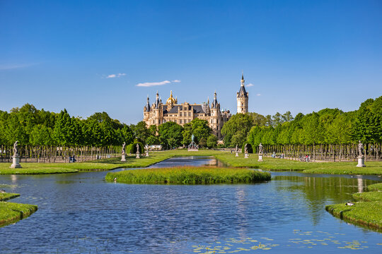 Schwerin Castle looking like a fairy tale castle surrounded by a wonderful landscape composed of lakes and forests 