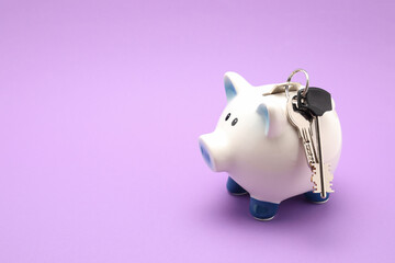 piggy bank with key for apartments isolated on color background 