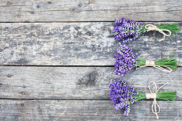 Obraz na płótnie Canvas Lavender bouquets on old wooden background, rustic wood table with lavender, banner copy space