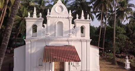 Zoom to rural white church in jungle in India
