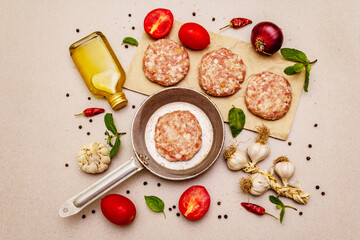 Raw cutlets, fresh vegetables, spices, olive oil. Vintage pan, picnic or barbecue cooking concept