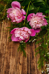 Fragrant pink peonies. Beautiful bouquet on vintage wooden background