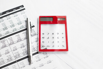 Calculator with pen on finance papers background