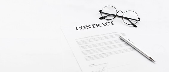 Signing contract with glasses nearby