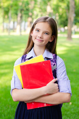 Fototapeta premium Back to school. Education concept. Cute smiling schoolgirl on the way to the school.