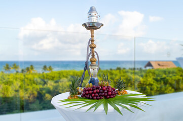 Tropical flavored hookah with jungle and sea background