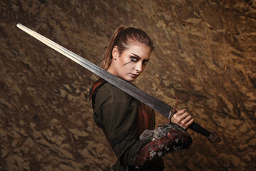 Beautiful warrior woman posing with sword